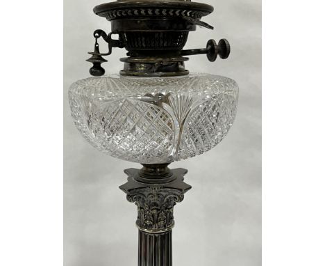 A Victorian plated corinthian oil lamp with Hink's duplex burner and cut clear glass fount. 25½" high excluding chimney. The 