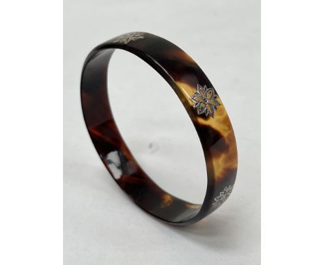 A Victorian tortoiseshell and silver inlaid bangle.