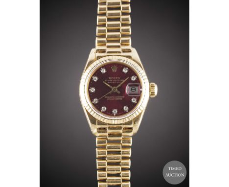A LADIES 18K SOLID GOLD ROLEX OYSTER PERPETUAL DATEJUST BRACELET WATCH
CIRCA 1978, REF. 6917 WITH REFINISHED "CHERRY RED" DIA
