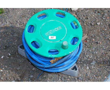 A coiled Hoselock garden hose pipe.