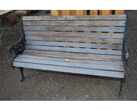 A 58" long bench with floral motif and heavy cast ends.