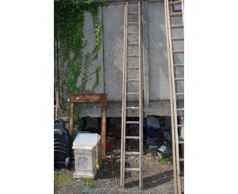 A thirteen rung single extension wooden Ladder.