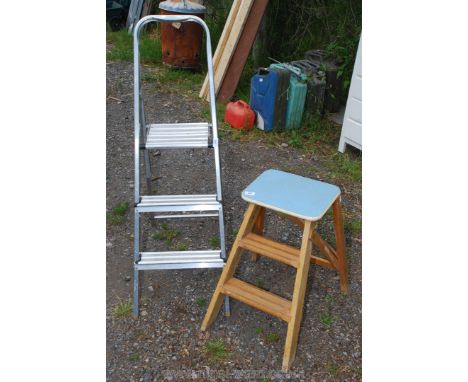 A wooden two stage kitchen steps and two step aluminium ladder.