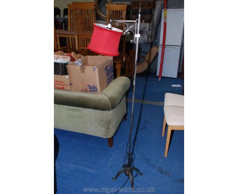 A wrought iron adjustable reading light.