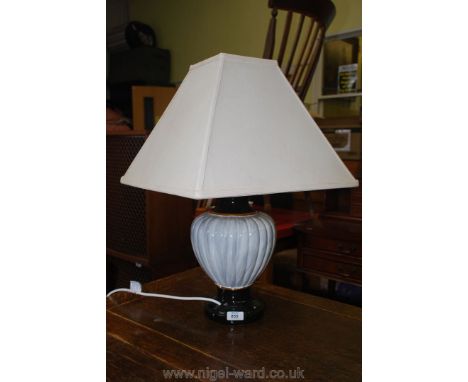 A pottery lamp and shade.