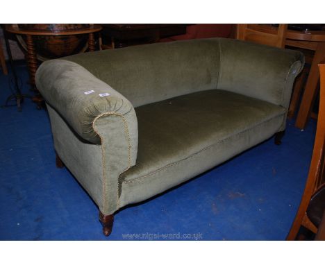 A green upholstered two seat sofa.