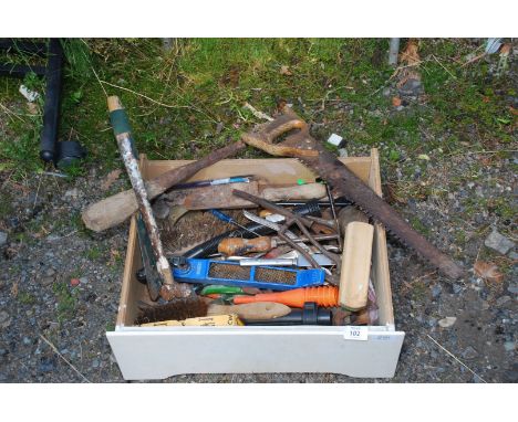 A white drawer of vintage garden and hand tools.