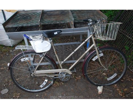 A Hercules ladies step through, three gear Bicycle with saddle bag, basket, etc.