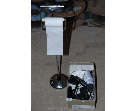 Cordless phones, timer clock and a chrome toilet roll holder.