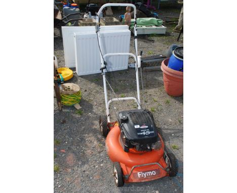 A Flymo self drive mower with Briggs &amp; Stratton engine. Quantum XTE45 petrol engine.Front near side wheel loose