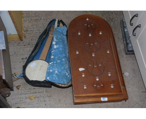 A Bagatelle board and a small banjo.