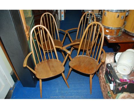 Four light coloured Ercol dining chairs.
