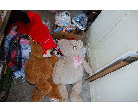 A trunk containing large teddies, picnic rug, Christmas stockings, lamp shades and hangers.