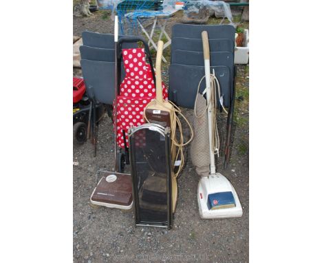 Two electric vaccums, carpet sweeper, fire guard and shopping trolley.