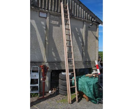 A sixteen rung single extension wooden Ladder.