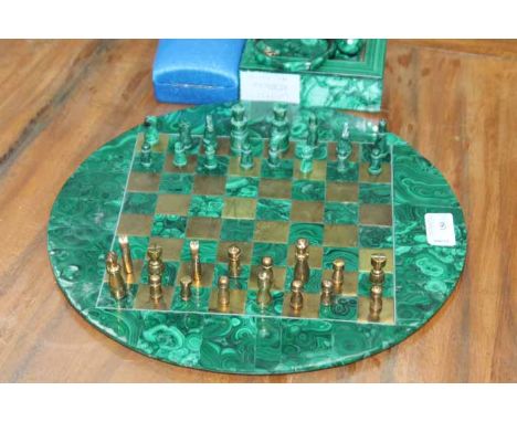 MALACHITE AND BRASS CHESS SET
of circular form, with malachite and brass pieces, 32.5cm in diameter; together with a malachit
