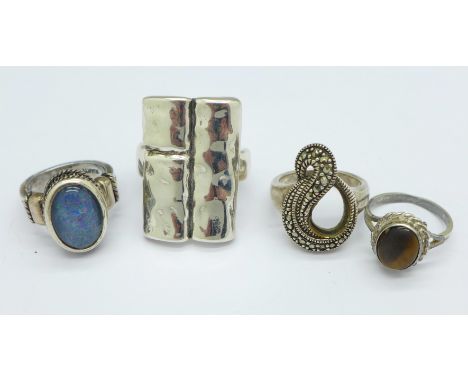 A Suarti silver and opal ring and three other silver rings, M x2, N and T