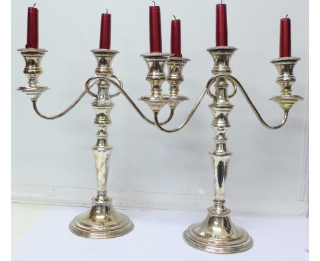 A pair of plated three branch candelabra