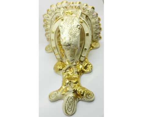 A gilt decorated china equine wall bracket