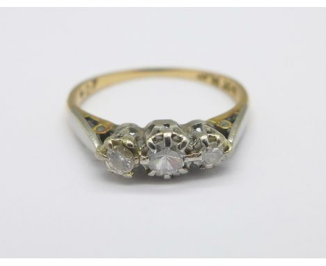 An 18ct gold, platinum set three stone diamond ring, 1.6g, K