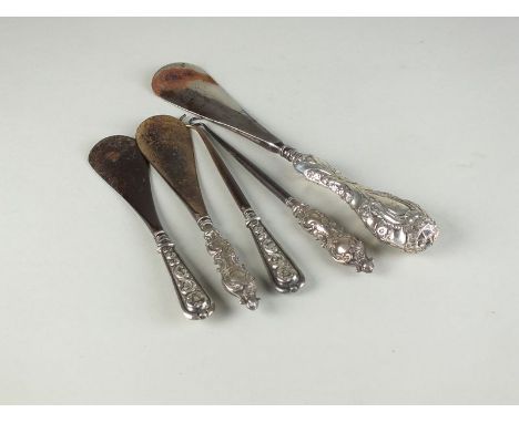 Three silver mounted shoe horns, together with two silver mounted button hooks, each hallmarked Birmingham (5)