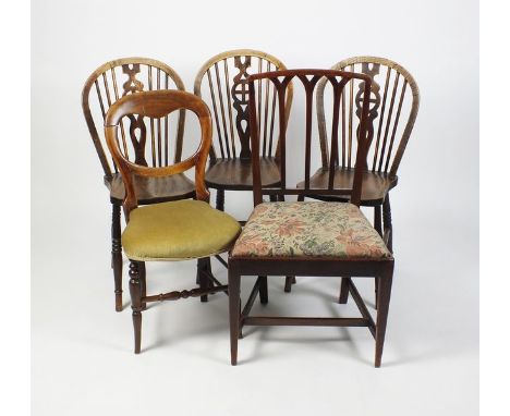 A miscellaneous collection of chairs to include three elm and ash wheel and stick back kitchen chairs, a Victorian mahogany b