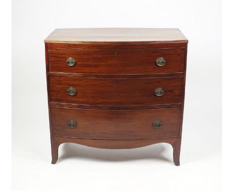 An early 19th century mahogany bowfront chest of three long graduated drawers above a shaped apron and on splay bracket feet,
