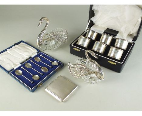 A cased set of six silver napkin rings, together with a cased set of six silver coffee spoons, two silver engine turned penci