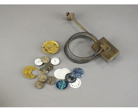 A collection of watchmakers tools, watch movements, dials etc