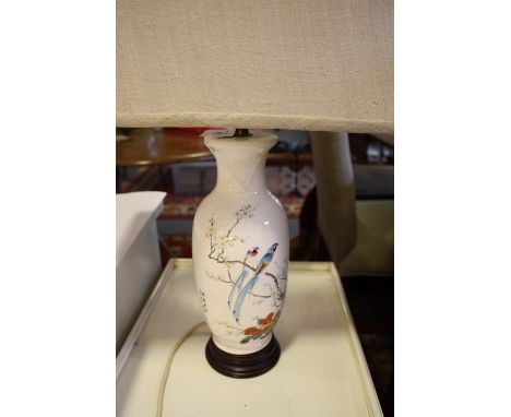 A ceramic baluster shaped table lamp, decorated with birds on a branch, with a rectangular shade, H. 56cm