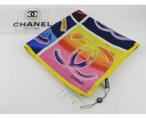 A Chanel silk head scarf, printed with 25 colourful interlocking C motifs on a shaded square grounds, 27cm x 30cm, in origina