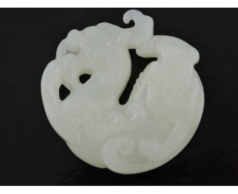 A mutton-fat jade pendant, carved in the form of a dragon, D. 5cm.