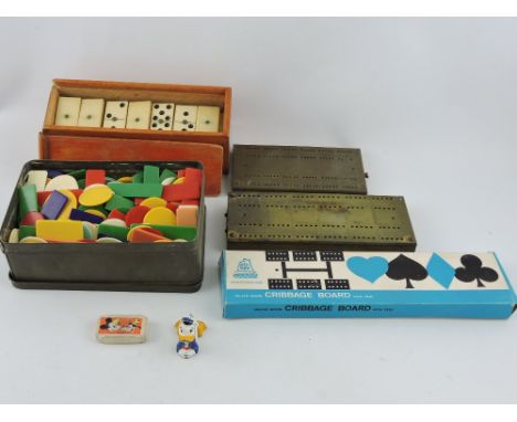 A Salco Donald Duck painted lead pencil sharpener, L. 4cm; together with cribbage boards, set of dominoes and plastic counter