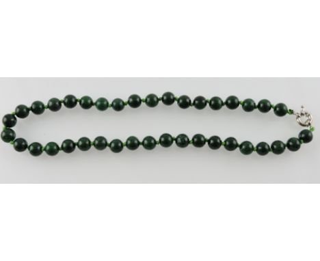 A string of uniform jade beads, L. 45cm.