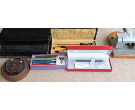 A collection of vintage desk accessories, including a Boston Model KS pencil sharpener, glass inkwell, an ebonised wood HM St