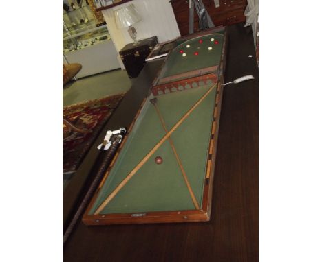 A late 19th century mahogany bagatelle table, complete with balls, cue and scorer inlaid to the edge. 