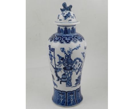 A Chinese blue and white baluster shaped vase, having lid with dog of Fo finial, decorated with Chinese ornaments, bears four