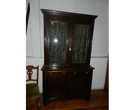 An Edwardian mahogany book case, having two short drawers over two astragal glazed doors, raised on carved bracket feet. H:21