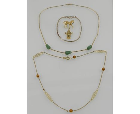 A yellow metal and tigers eye necklace, together with a yellow metal and jade necklace, a yellow metal chain bracelet, an 18 