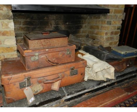 Three graduated vintage tan leather suitcases, together with a leather desk set and a white canvas fencing jacket and glove, 