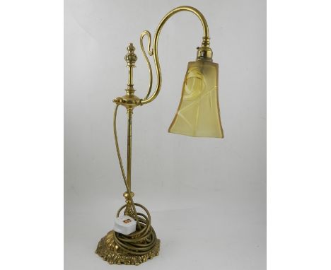 A brass standing table lamp, having glass shade. H.56cm