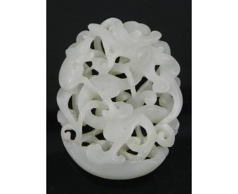 A carved jade pendant, decorated with scrolling foliage. H.6cm