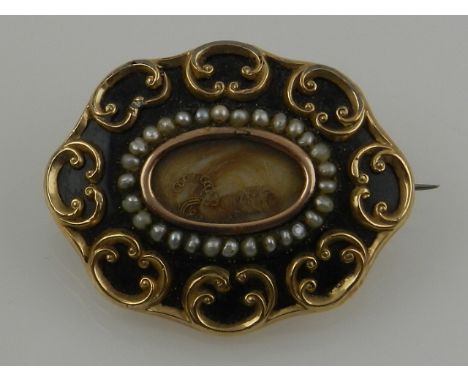 A Victorian Momento Mori yellow metal, enamel, and seed pearl brooch, with central glass aperture containing a lock of hair, 