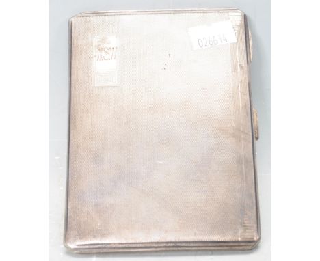A 1930s silver hallmarked cigarette case of rectangular form with engine turned decoration to both sides and the initials W.S