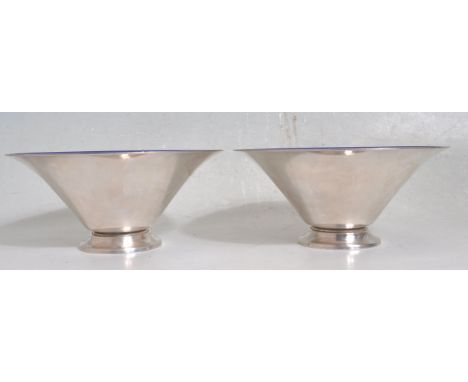 Meka of Denmark - A pair of vintage 20th century white metal and blue enamel bowls of tapering form raised on a circular lipp
