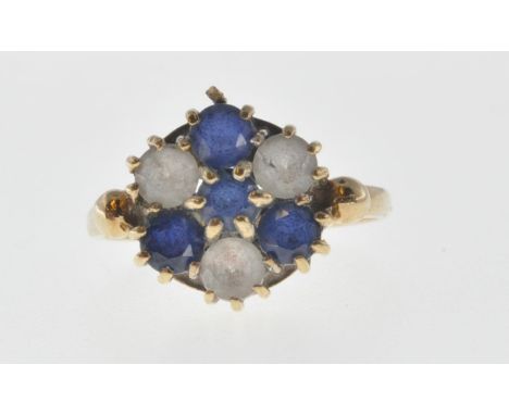 A hallmarked 9ct gold cluster ring set with seven round cut blue and white stones. Hallmarked London 1974. Weight 2.6g Size K