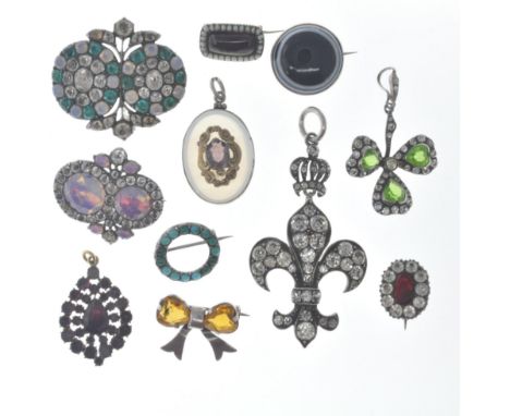 A group of antique brooches and pendants to include two silver and paste set brooches, a Charles Horner silver bow brooch set