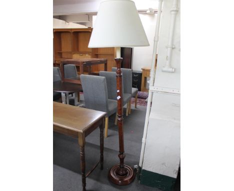 A contemporary mahogany standard lamp with shade 