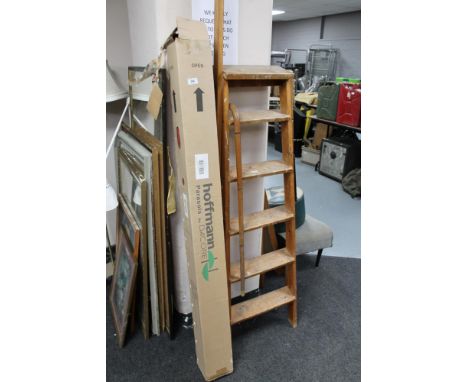 A garden parasol in box together with a wooden ladder and walking stick 