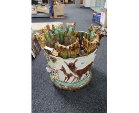 An encrusted potter planter decorated with fawns etc 